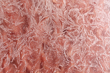 Fototapeta premium close-up frost pattern, frozen background on red 