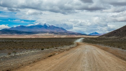 lonely road in the bolivian altiplano