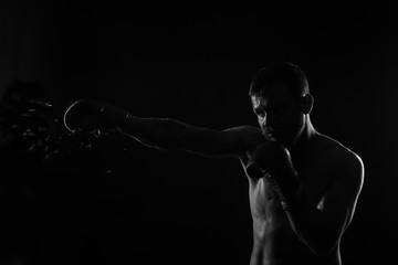 Athletic bearded boxer with gloves on a dark background - 90699536