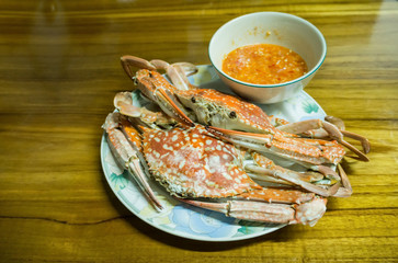 Steamed crabs with seafood souce on dish close-up