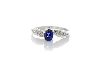 Ring of the jewelry with colourful sapphire on the white backgro