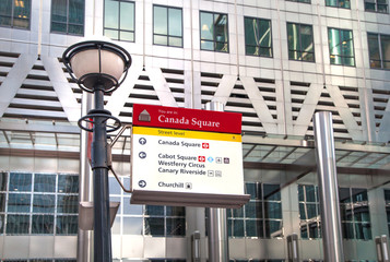 LONDON, CANARY WHARF UK - MARCH 2, 2015: Modern architecture of Canary Wharf and sign post