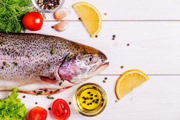 Raw trout with spices on a light  background