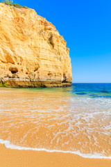 Ocean wave on golden sand Centianes beach, Portugal