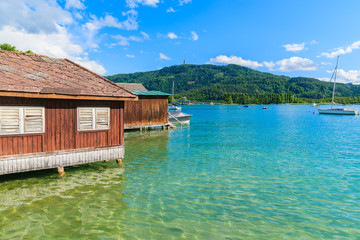 Fototapeta na wymiar Wooden traditional boat house on shore of Worthersee lake in summer, Austria