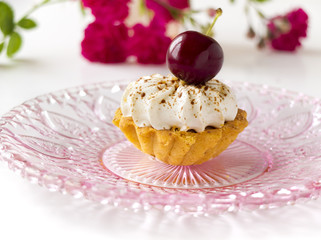 Cupcakes (three cakes) with cherries and whipped cream
