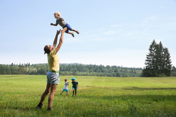 Mother playing with children
