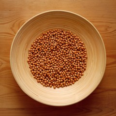 Bamboo Bowl with Chickpeas on Wood Background