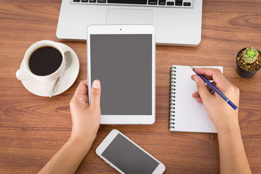 Female Hands Holding A Computer Tablet On The Table In The Offic