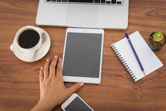 Female Hands Holding A Computer Tablet On The Table In The Offic