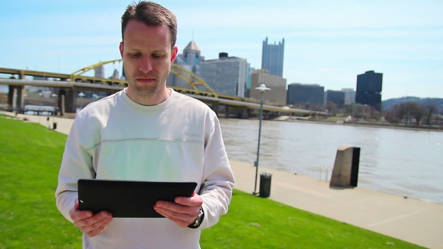 Man Using an iPad Outside