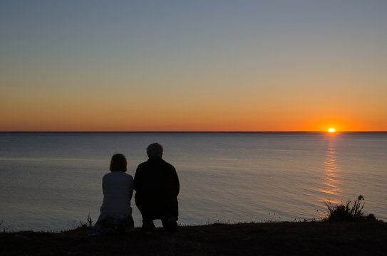 Couple at the coast by sunset