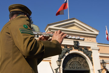 Carabinero music band playing outside the historic fish market in the centre of Santiago in Chile. - obrazy, fototapety, plakaty