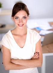 Naklejka premium Attractive businesswoman with her arms crossed standing in