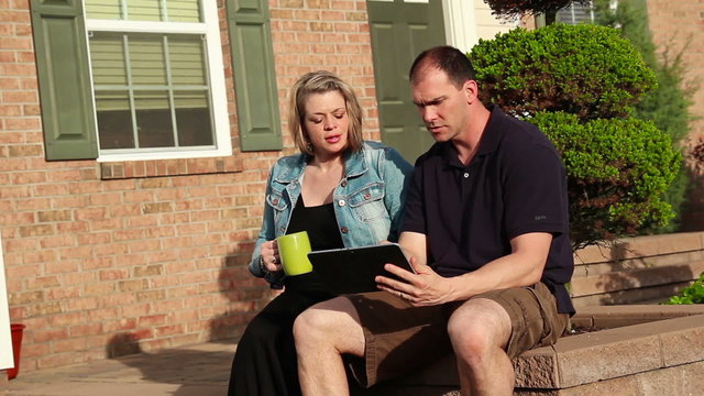 Couple with iPad Outside