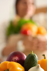 Young woman standing near desk in the kitchen