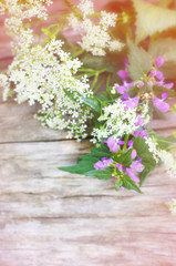 Summer flowers on wooden blurred background