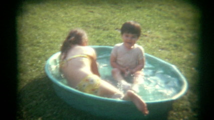 Vintage Film Kids Play in Kiddie Pool - Powered by Adobe