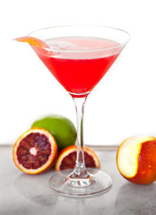 A delicious sweet mixed drink cocktail fruity pink ruby red martini glass blood orange