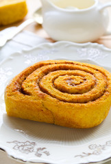 Homemade pumpkin cinnamon rolls with spices and sweet cream