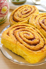 Homemade pumpkin cinnamon rolls with spices and sweet cream