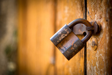 Old rusty lock on the vintage wooden door