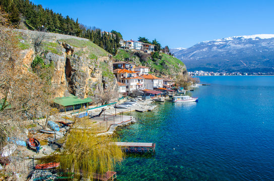 small houses are spread over a cliff near path leading to the saint johan at kaneo church in macedonian town ohrid.