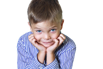 Smiling sly boy looks at the camera