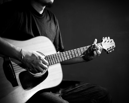 Man playing guitar. Black and white photo.