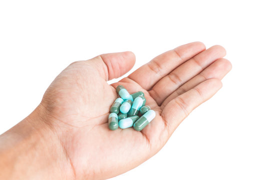 pill in male hand on white background isolated