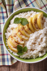Rice with caramelized apples in a bowl close-up. vertical top view
