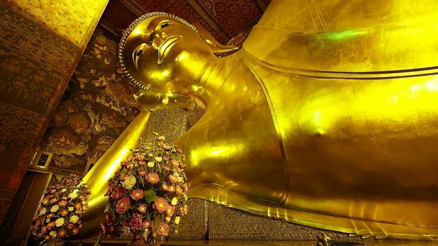 The iconic Reclining Buddha statue at Wat Pho temple in Bangkok, Thailand.