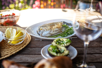 Grilled fish on white plate.