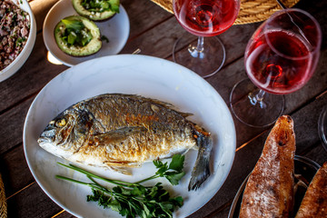 Grilled fish on white plate.