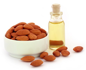 Fresh almonds with bottle of oil