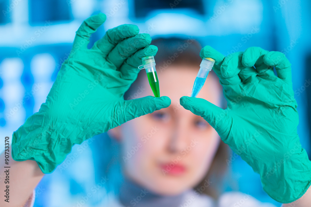 Wall mural Woman doing experiments in a lab