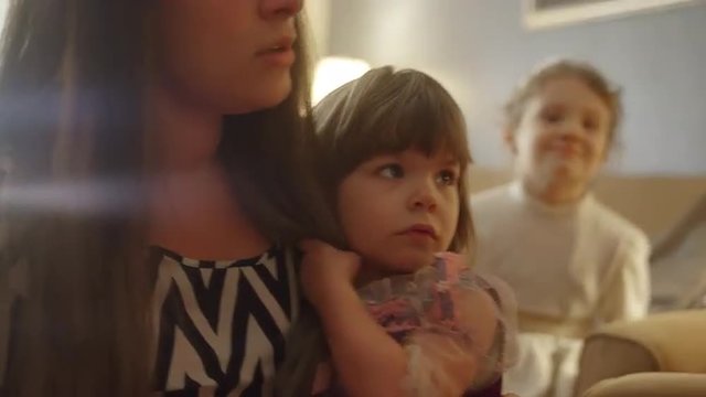 A mother helps her daughters apologize and get along after a fight
