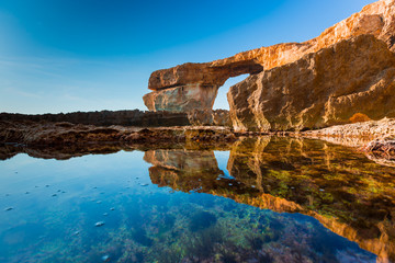 Fototapeta na wymiar Azure Window, famous stone arch on Gozo island with reflection,