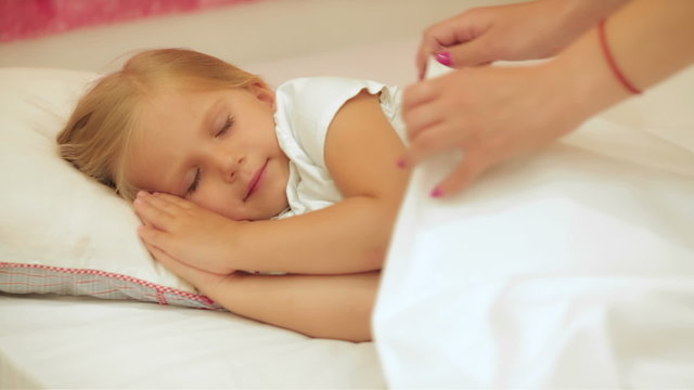 Adorable little girl sleep in the bed