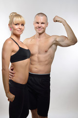 Fototapeta na wymiar Athletic middle-age man and woman posing in studio