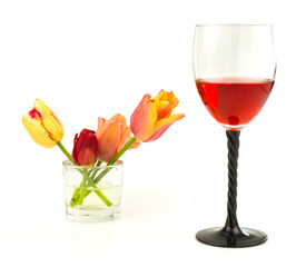 Glass of wine with flowers tulips