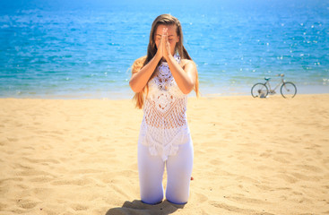 Fototapeta na wymiar girl in lace closed eyes in yoga asana on knees touch hands