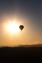 One Balloon over cappadoia in front of golden sun