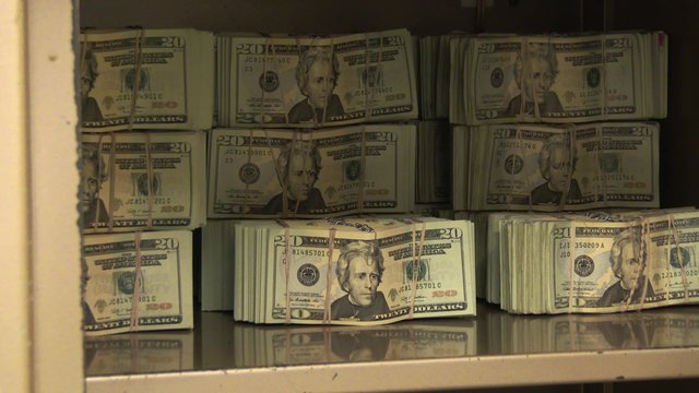 A Bank Vault Opens Revealing Stacks of Money Inside