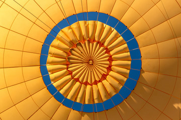 Opening the yellow top of an hot hair balloon