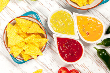 Plate of nachos with different dips