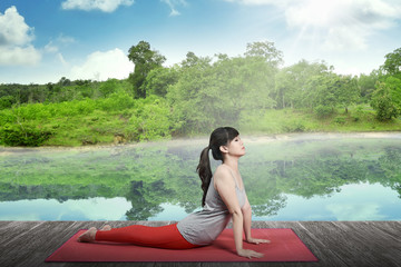 Woman Doing Yoga At The Lake