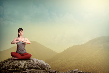 Naklejka na ściany i meble Woman Doing Yoga At The Mountain