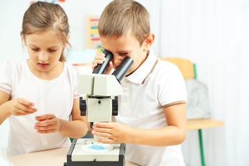 Obraz premium Cute pupils doing biochemistry research in chemistry class