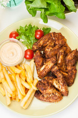 Chicken wings with fries french and spicy sauce